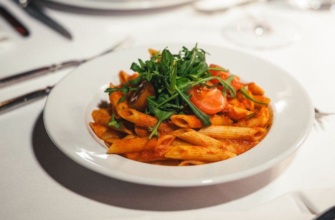 Penne with tomato sauce, cherry tomatoes and rocket