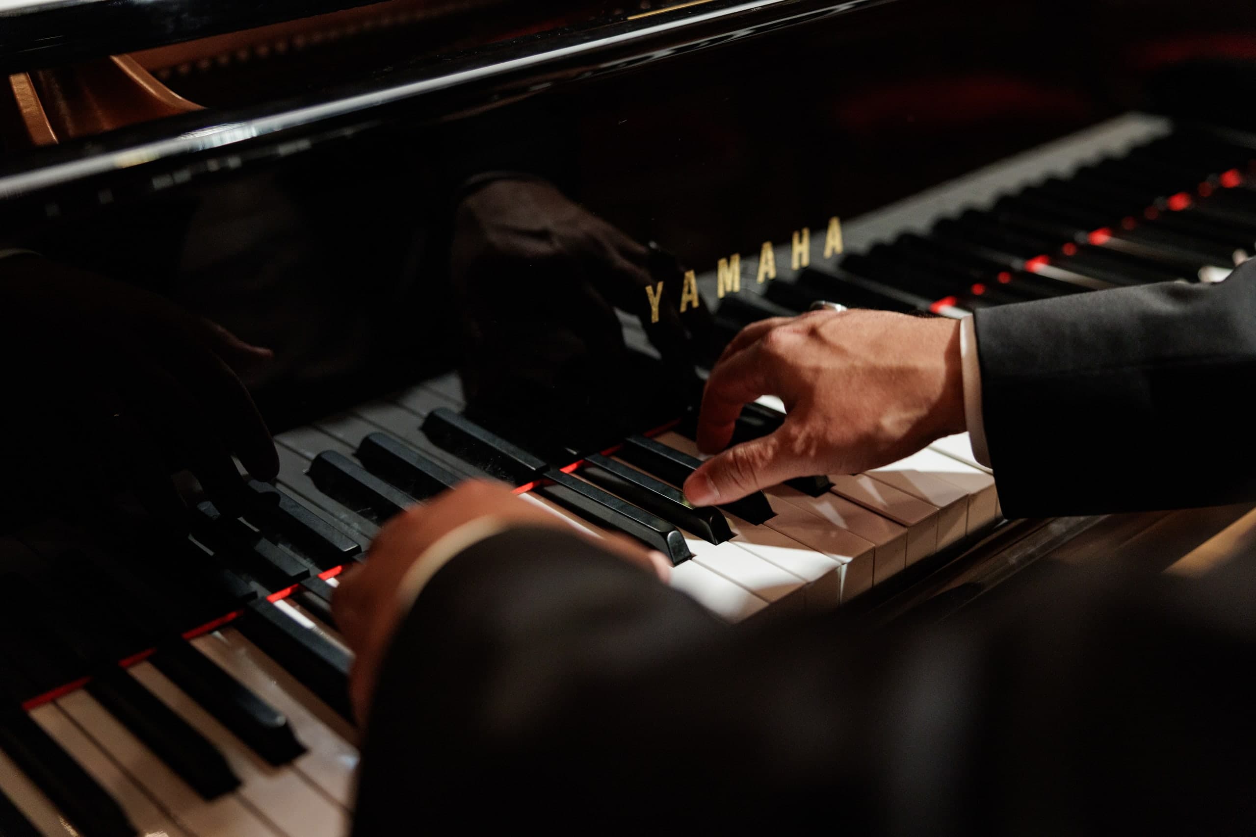 Pianist’s hands on the keyboard of a grand piano